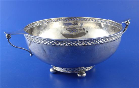 A George V Arts & Crafts planished silver circular two handled bowl by A.E. Jones, 13 oz.